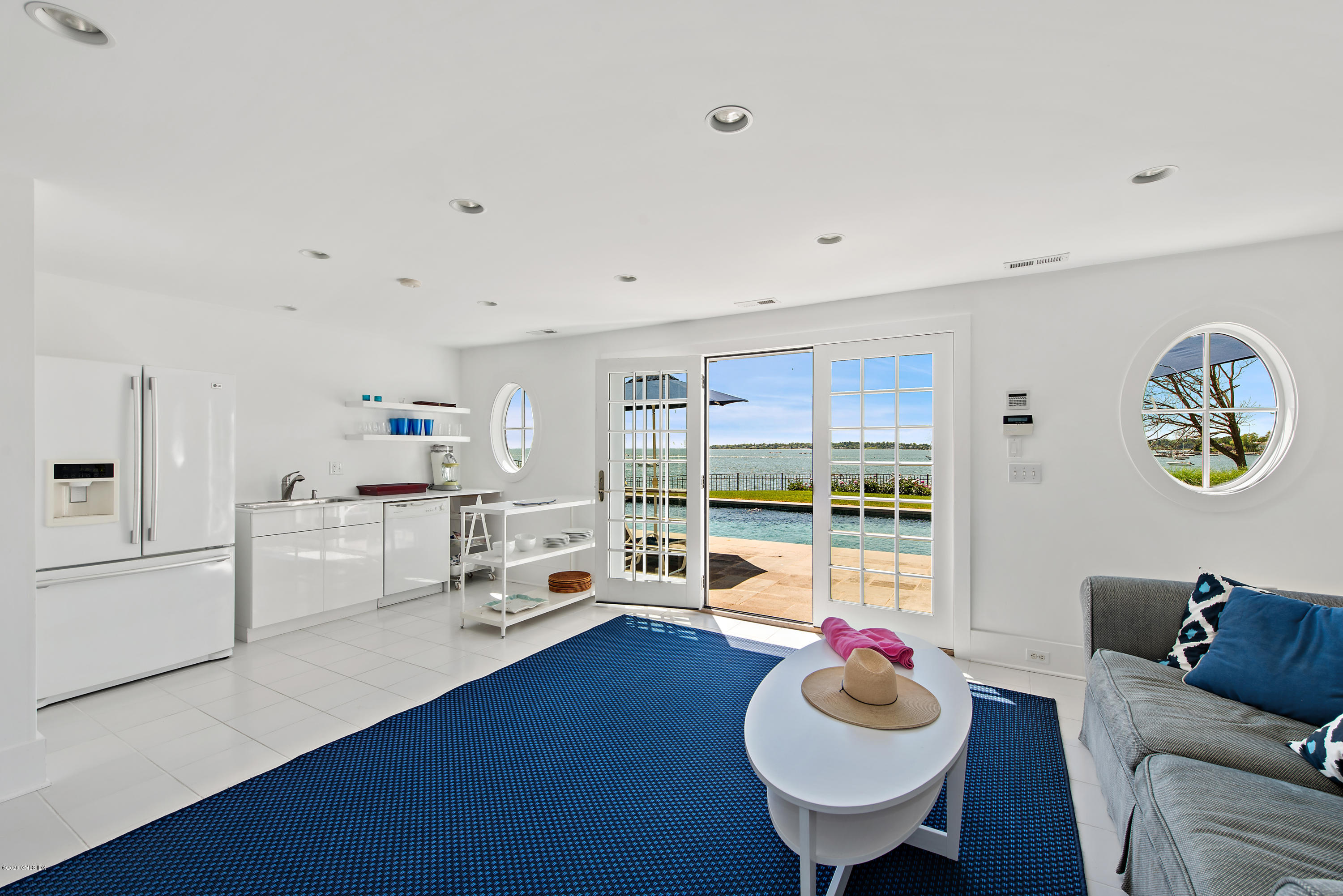 224 Long Neck Point Road Darien, CT 06820 - Photo 29 of 33 a living room with kitchen island furniture and a wooden floor