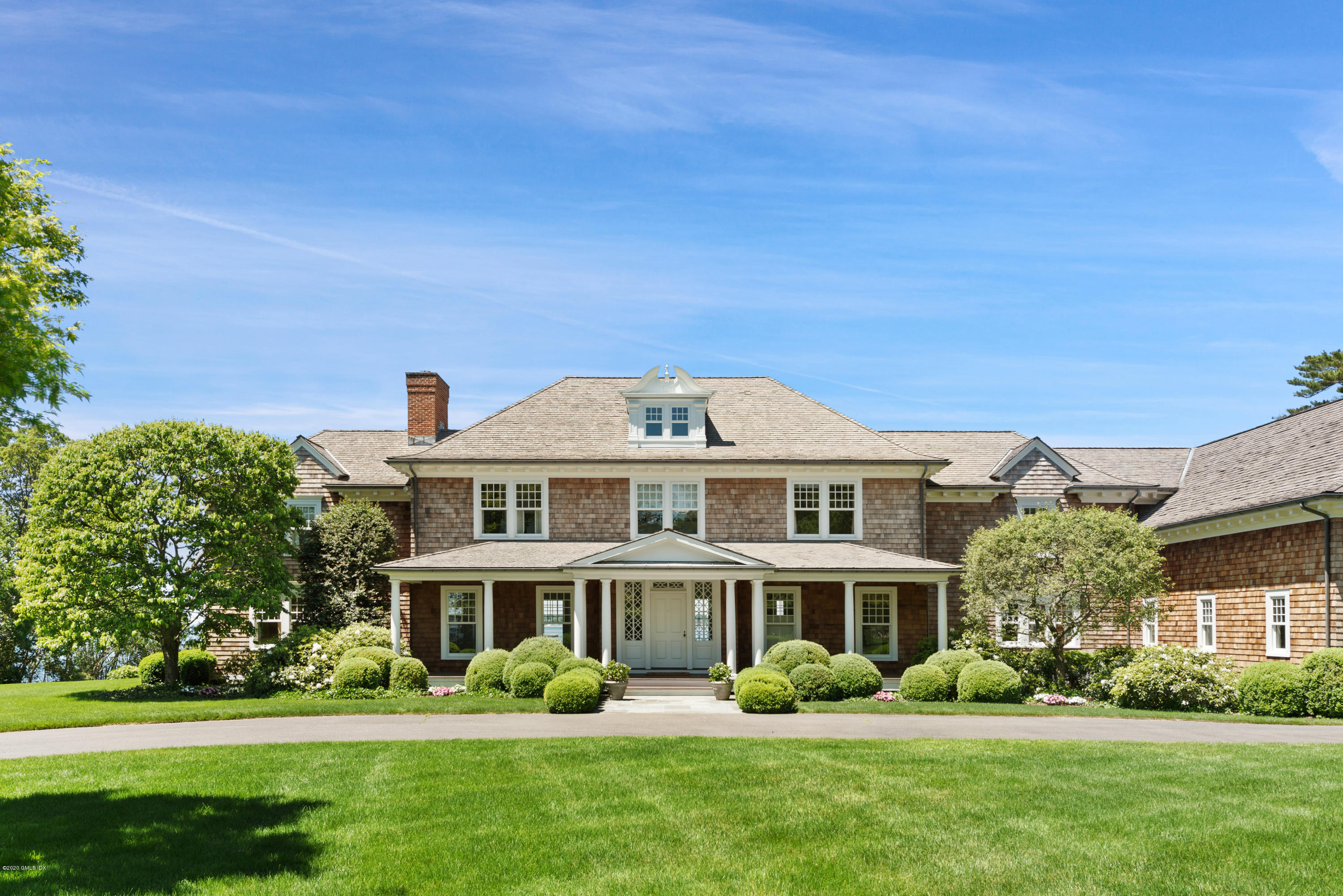 224 Long Neck Point Road Darien, CT 06820 - Photo 3 of 33 a front view of a house with a garden