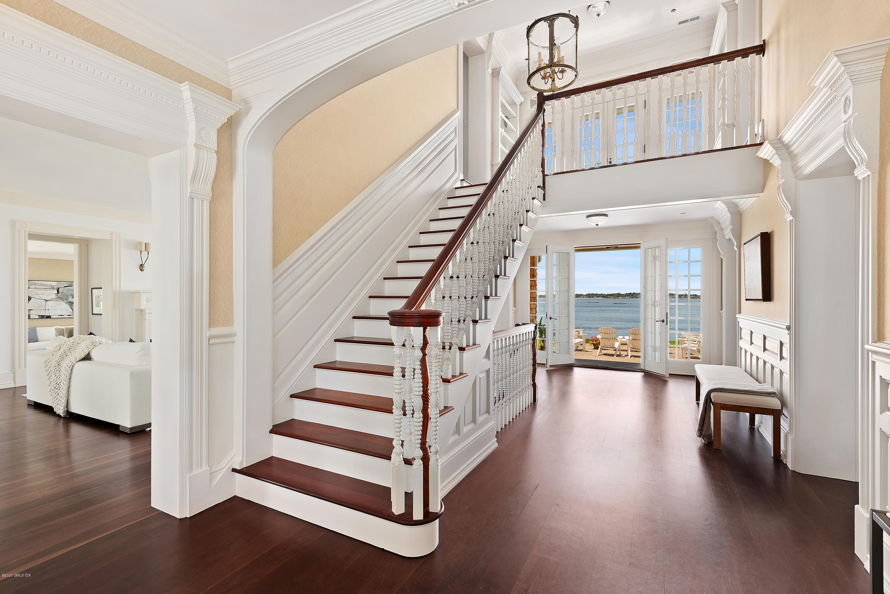 224 Long Neck Point Road Darien, CT 06820 - Photo 4 of 33 a view of staircase with white walls and wooden floor