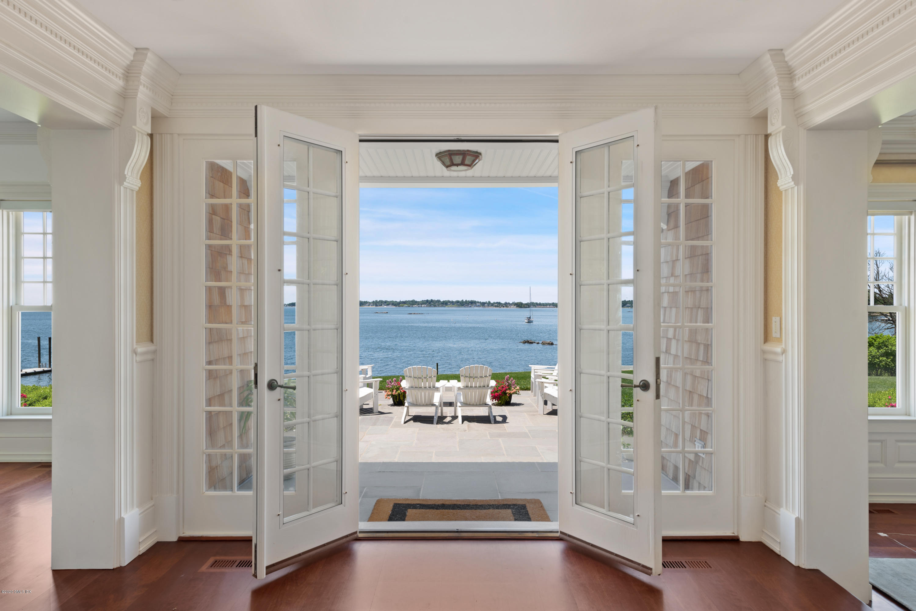 224 Long Neck Point Road Darien, CT 06820 - Photo 5 of 33 a view of a hallway with wooden floor and windows
