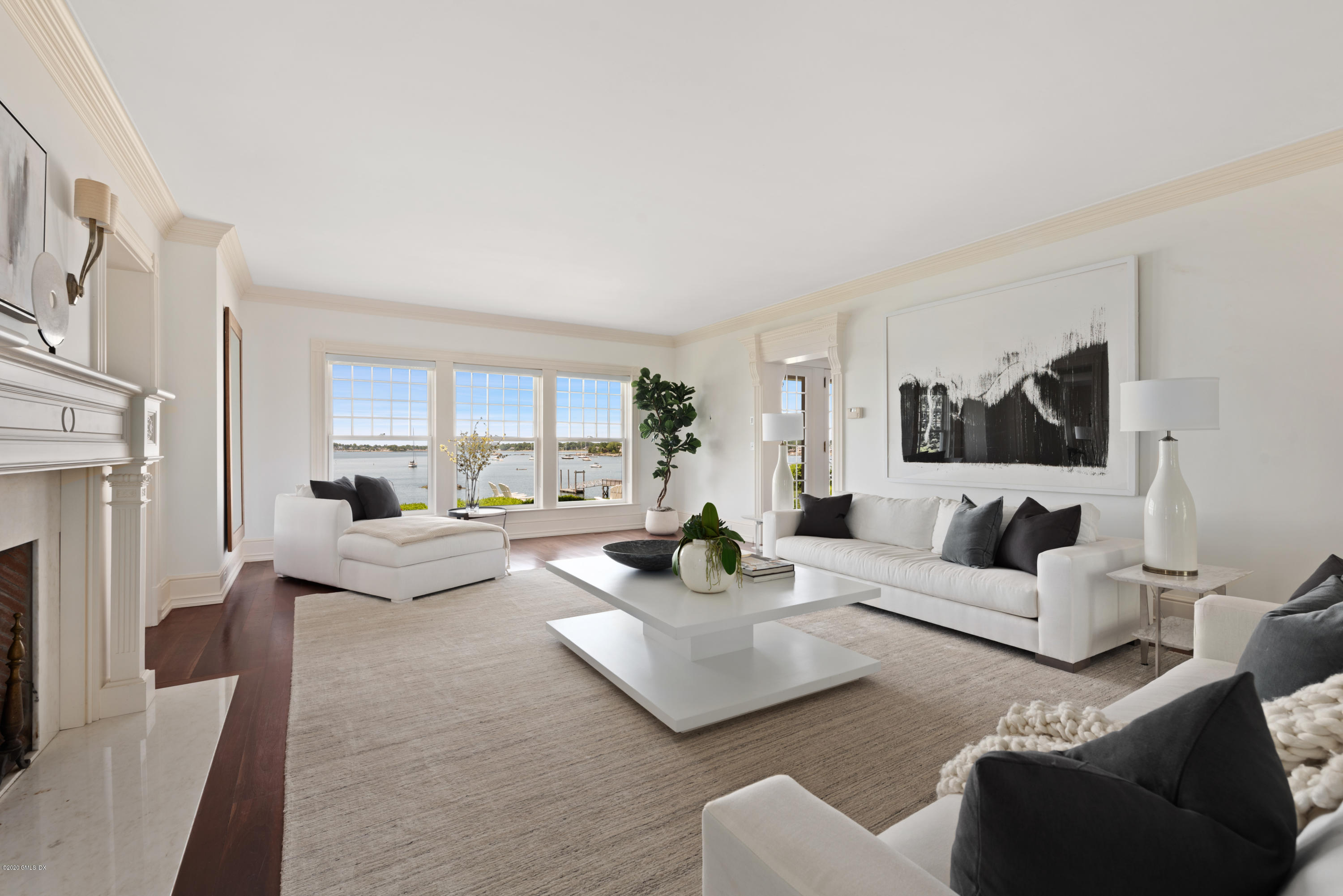 224 Long Neck Point Road Darien, CT 06820 - Photo 7 of 33 a living room with furniture and a fireplace