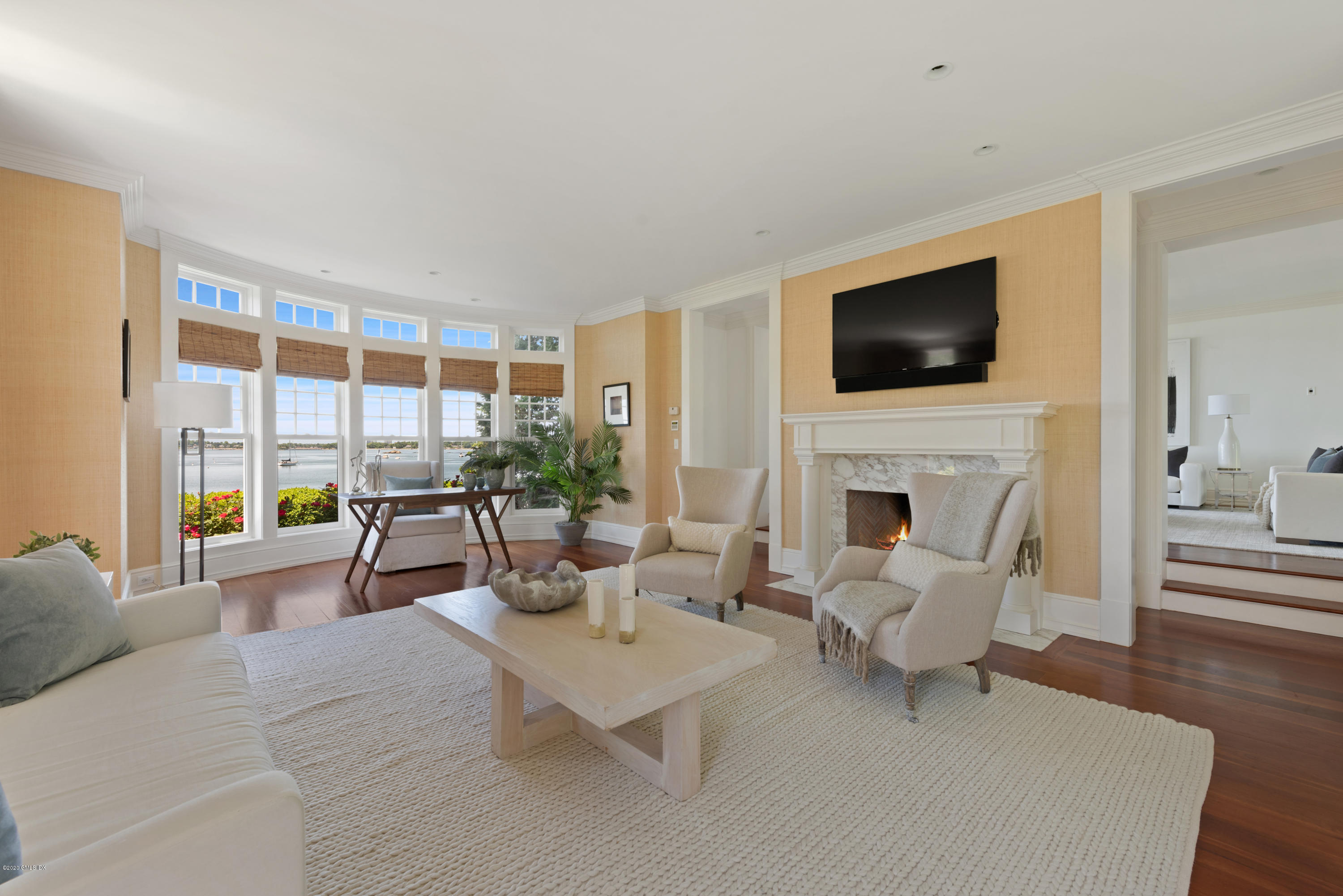 224 Long Neck Point Road Darien, CT 06820 - Photo 10 of 33 a living room with furniture a fireplace and a flat screen tv