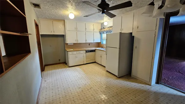 a kitchen with stainless steel appliances a refrigerator and a stove