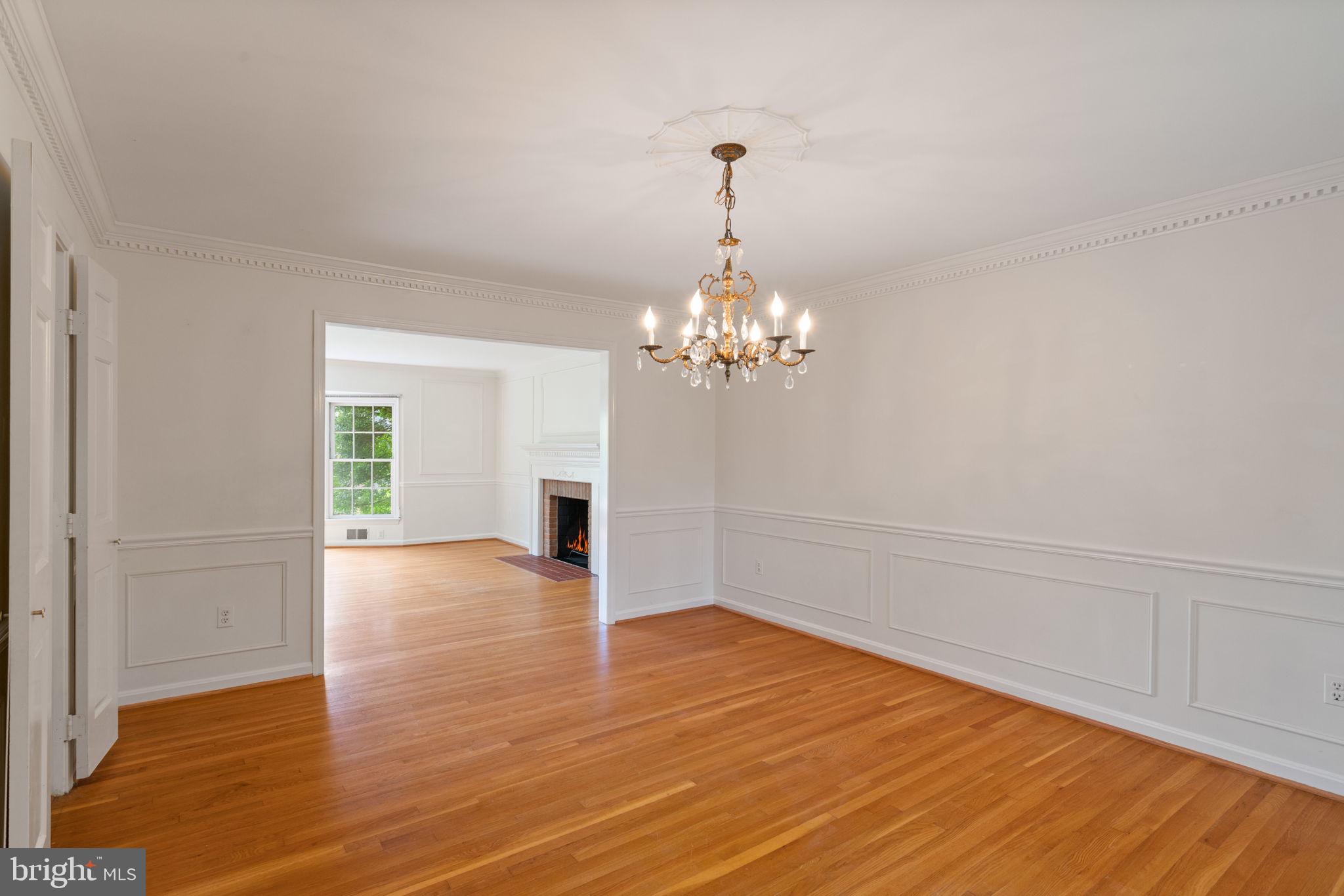 6716 Baron Road McLean, VA 22101 - Photo 16 of 41 a view of empty room with wooden floor and chandelier