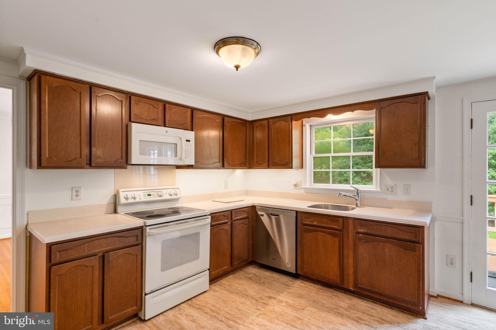 6716 Baron Road McLean, VA 22101 - Photo 18 of 41 a kitchen with a sink stove and cabinets
