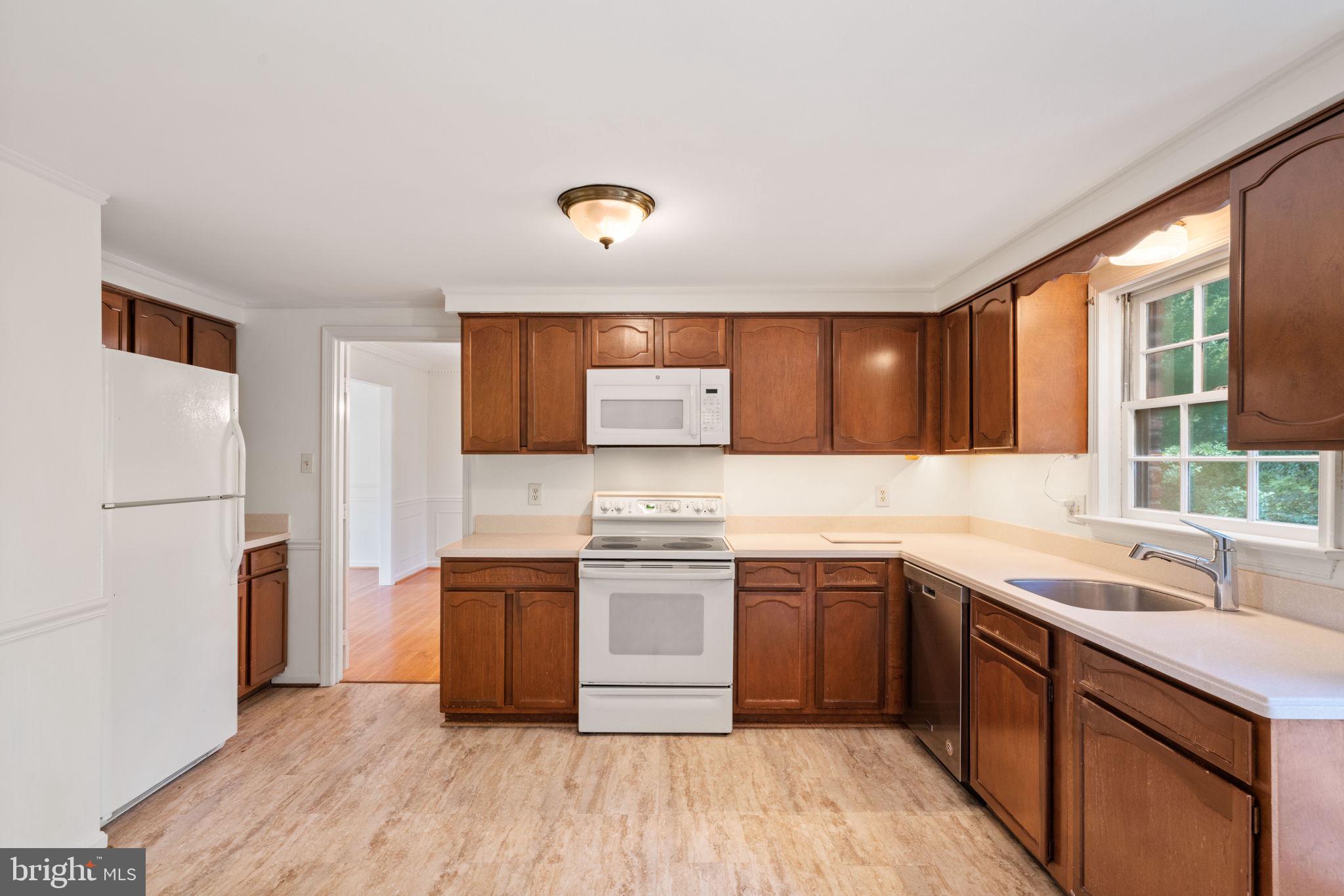 6716 Baron Road McLean, VA 22101 - Photo 20 of 41 a kitchen with stainless steel appliances granite countertop a sink stove and refrigerator