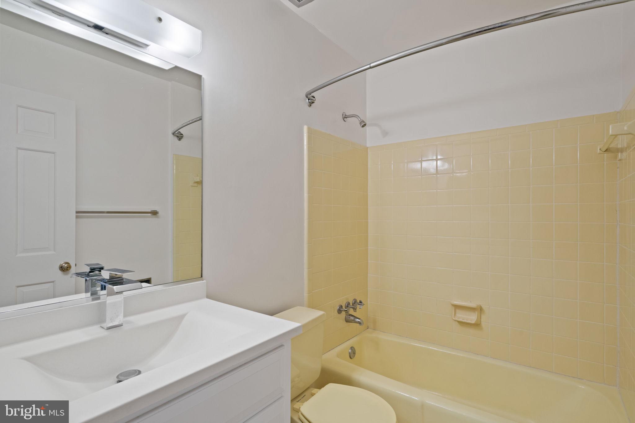6716 Baron Road McLean, VA 22101 - Photo 29 of 41 a bathroom with a sink mirror toilet and bathtub