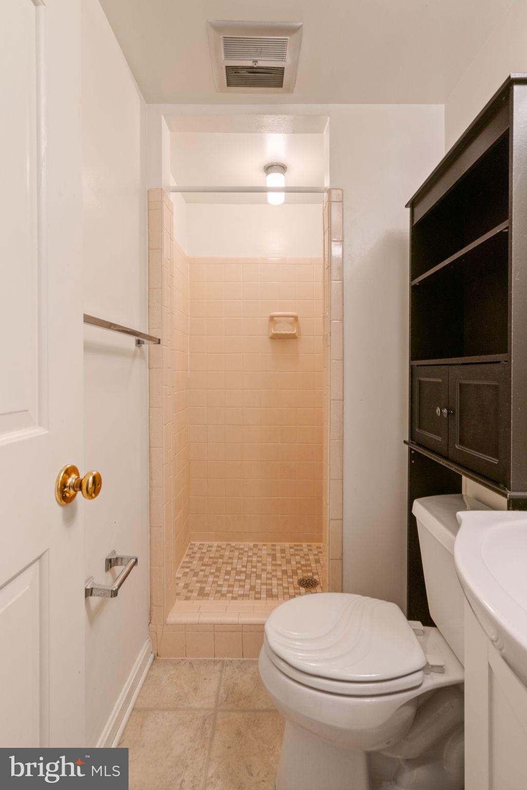 6716 Baron Road McLean, VA 22101 - Photo 37 of 41 a white toilet sitting next to a bathroom sink and a shower
