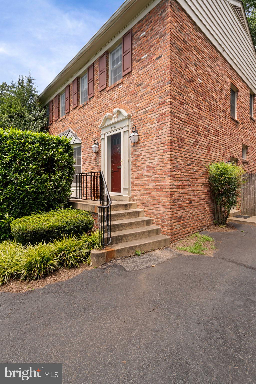 6716 Baron Road McLean, VA 22101 - Photo 5 of 41 a front view of a house with a yard and plants