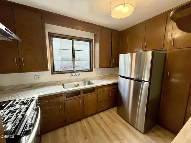 a kitchen with stainless steel appliances a refrigerator and a sink