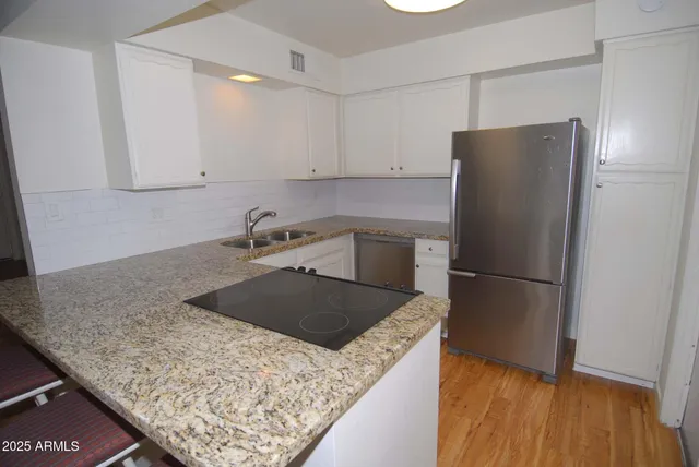 a kitchen with a refrigerator and a sink