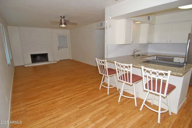 a view of a kitchen with granite countertop stainless steel appliances and wooden floor