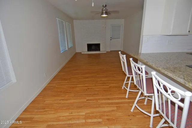 a view of a livingroom with wooden floor and staircase