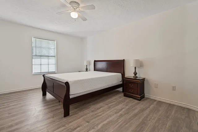 a bedroom with a bed and wooden floor