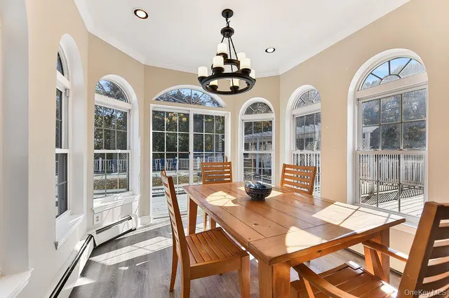 a view of a dining room with furniture wooden floor and chandelier