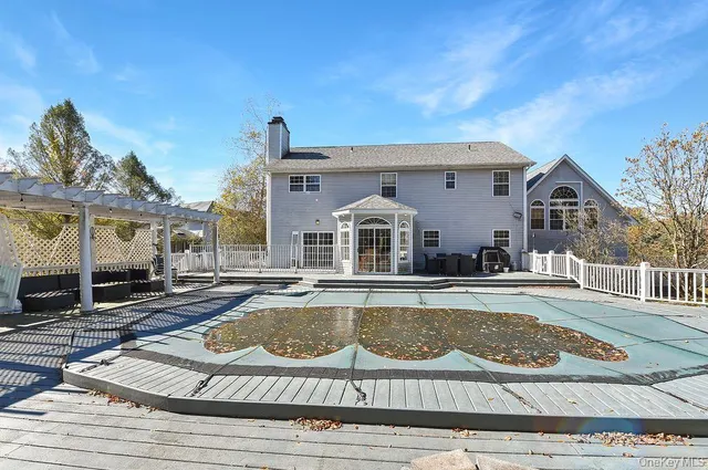 a bathroom with a granite countertop tub sink and mirror