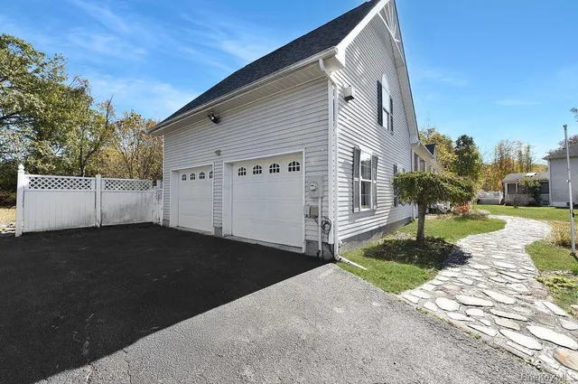 a backyard of a house with table and chairs