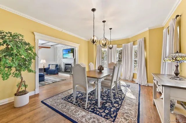 a view of a dining room with furniture window and wooden floor
