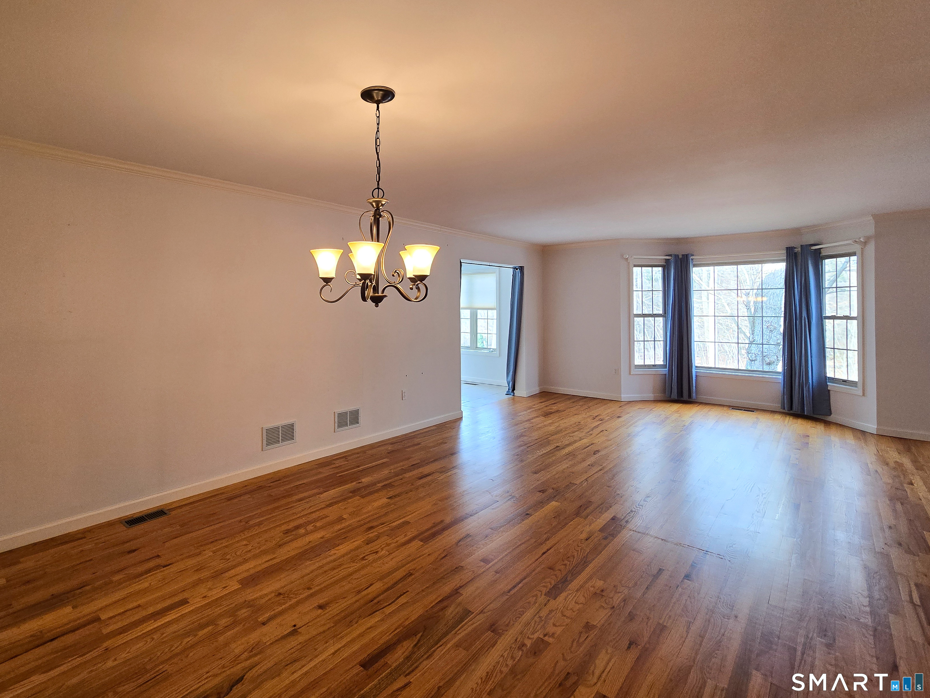 1 Bittersweet Lane, Unit 1 East Lyme, CT 06357 - Photo 12 of 35 a view of a room with wooden floor chandelier and windows