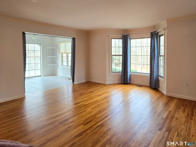 a bathroom with a granite countertop toilet sink and mirror