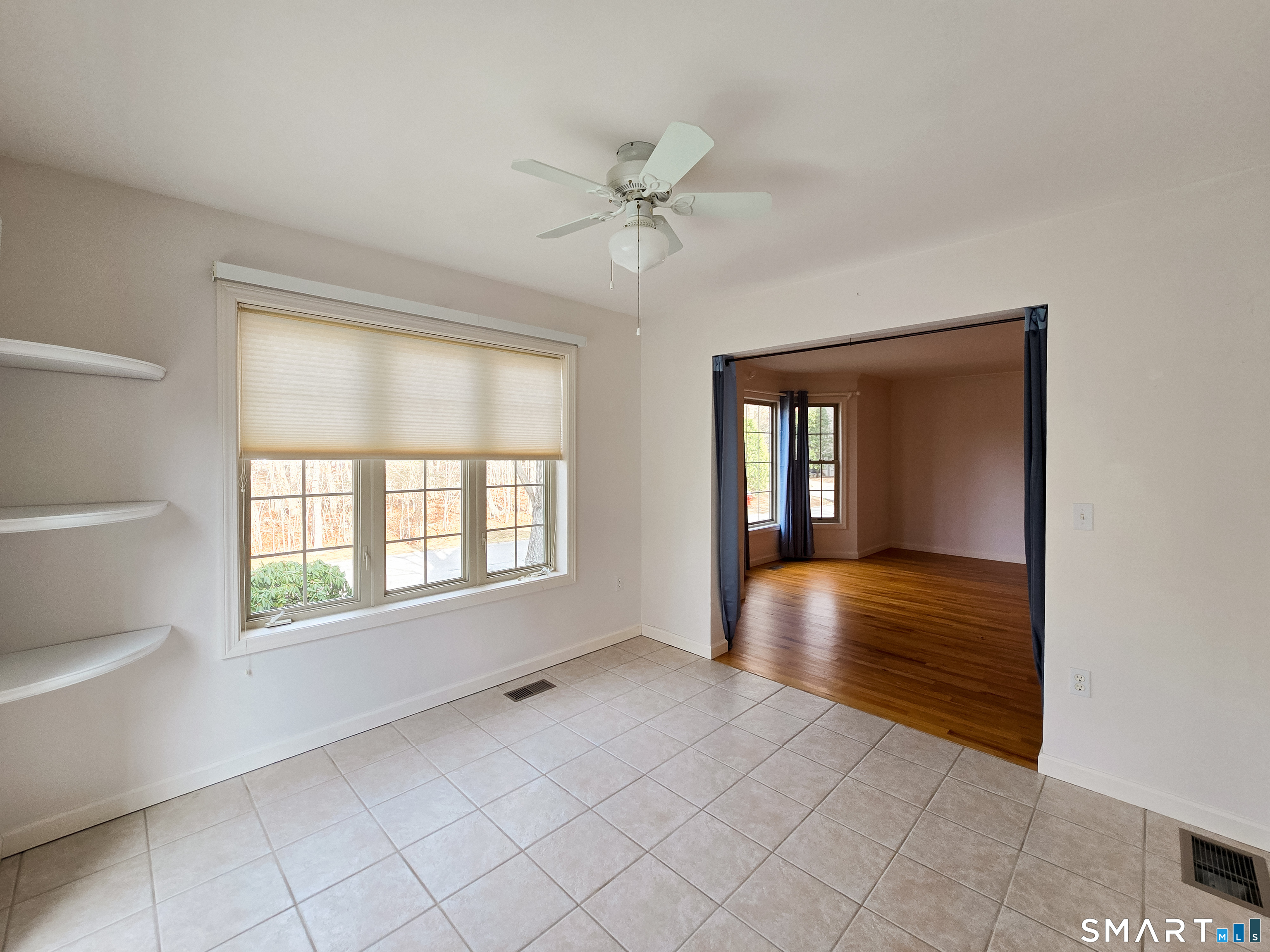 1 Bittersweet Lane, Unit 1 East Lyme, CT 06357 - Photo 17 of 35 a view of an empty room with a window and a kitchen
