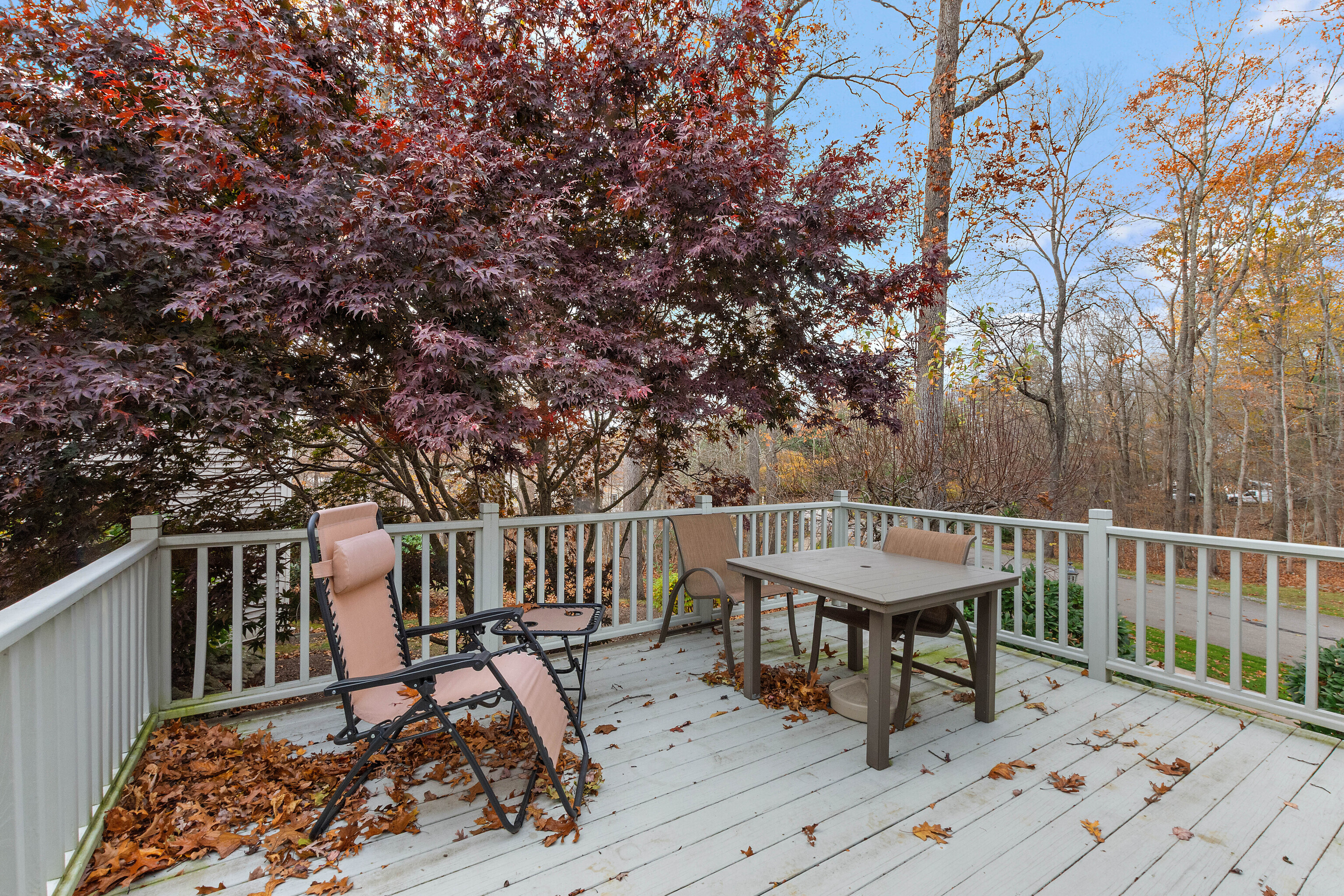 1 Bittersweet Lane, Unit 1 East Lyme, CT 06357 - Photo 18 of 35 a view of a roof deck with table and chairs and wooden floor