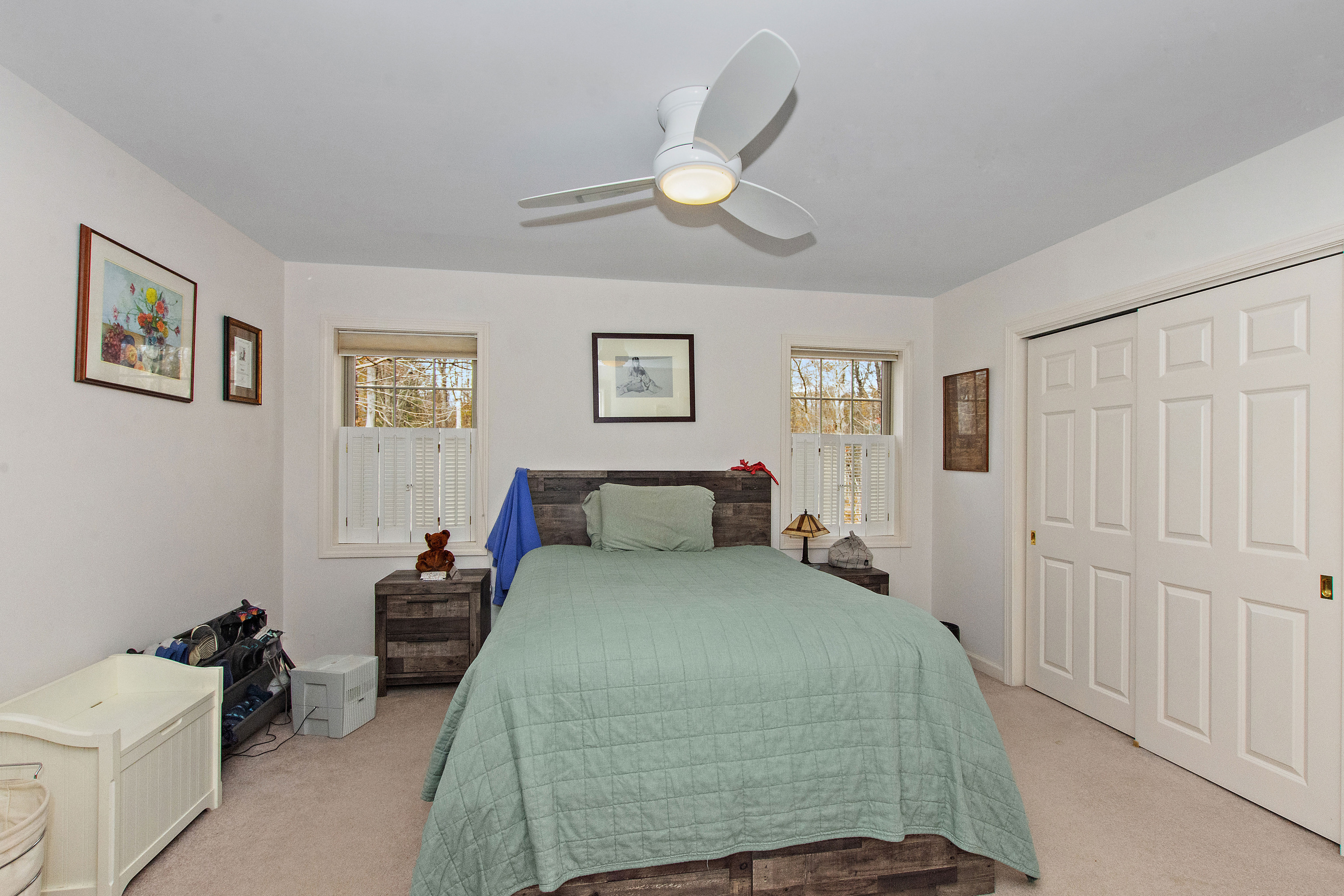 1 Bittersweet Lane, Unit 1 East Lyme, CT 06357 - Photo 19 of 35 a bedroom with a bed and a chandelier