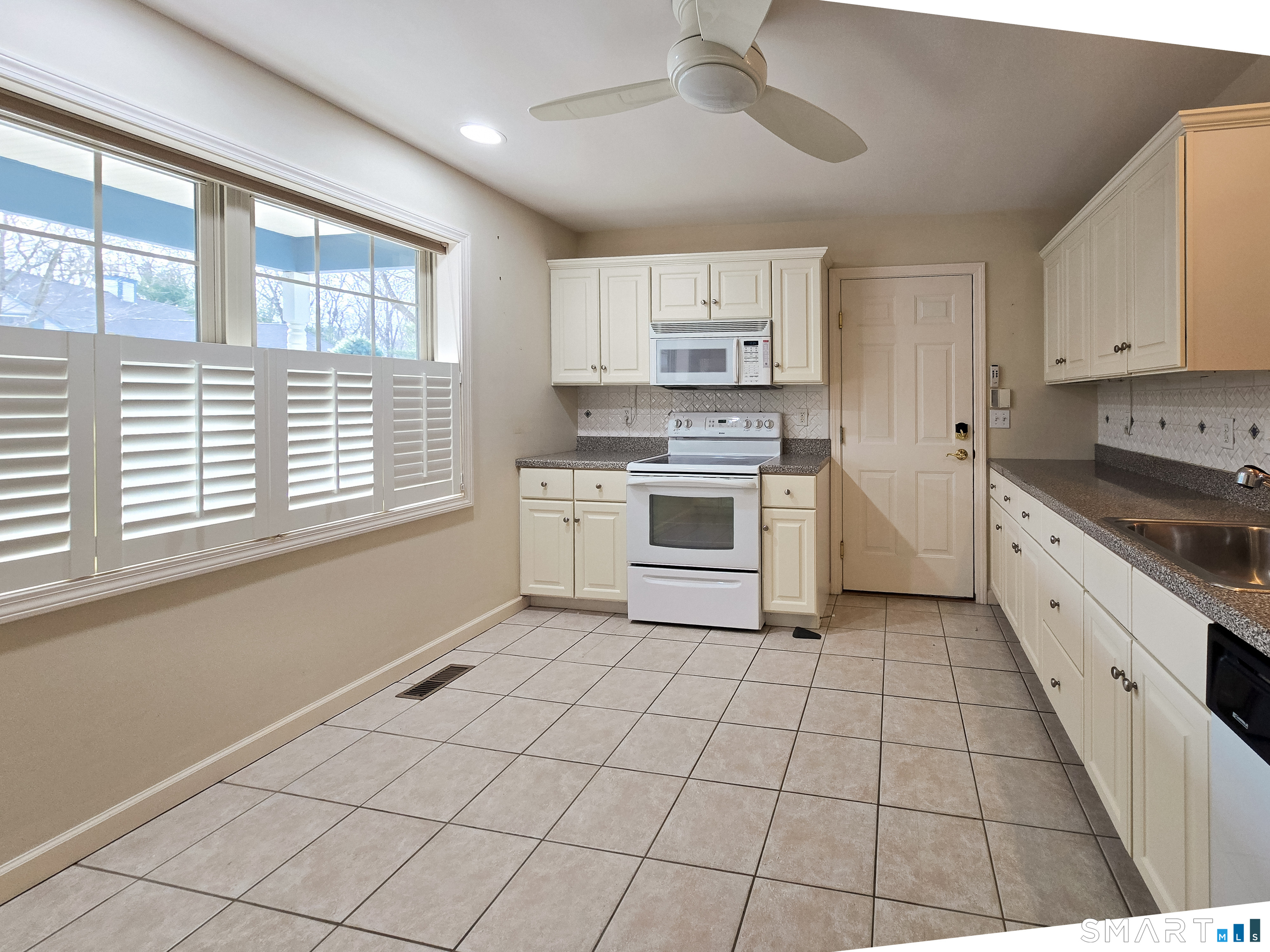 1 Bittersweet Lane, Unit 1 East Lyme, CT 06357 - Photo 6 of 35 a kitchen with stainless steel appliances granite countertop a stove a sink and a refrigerator