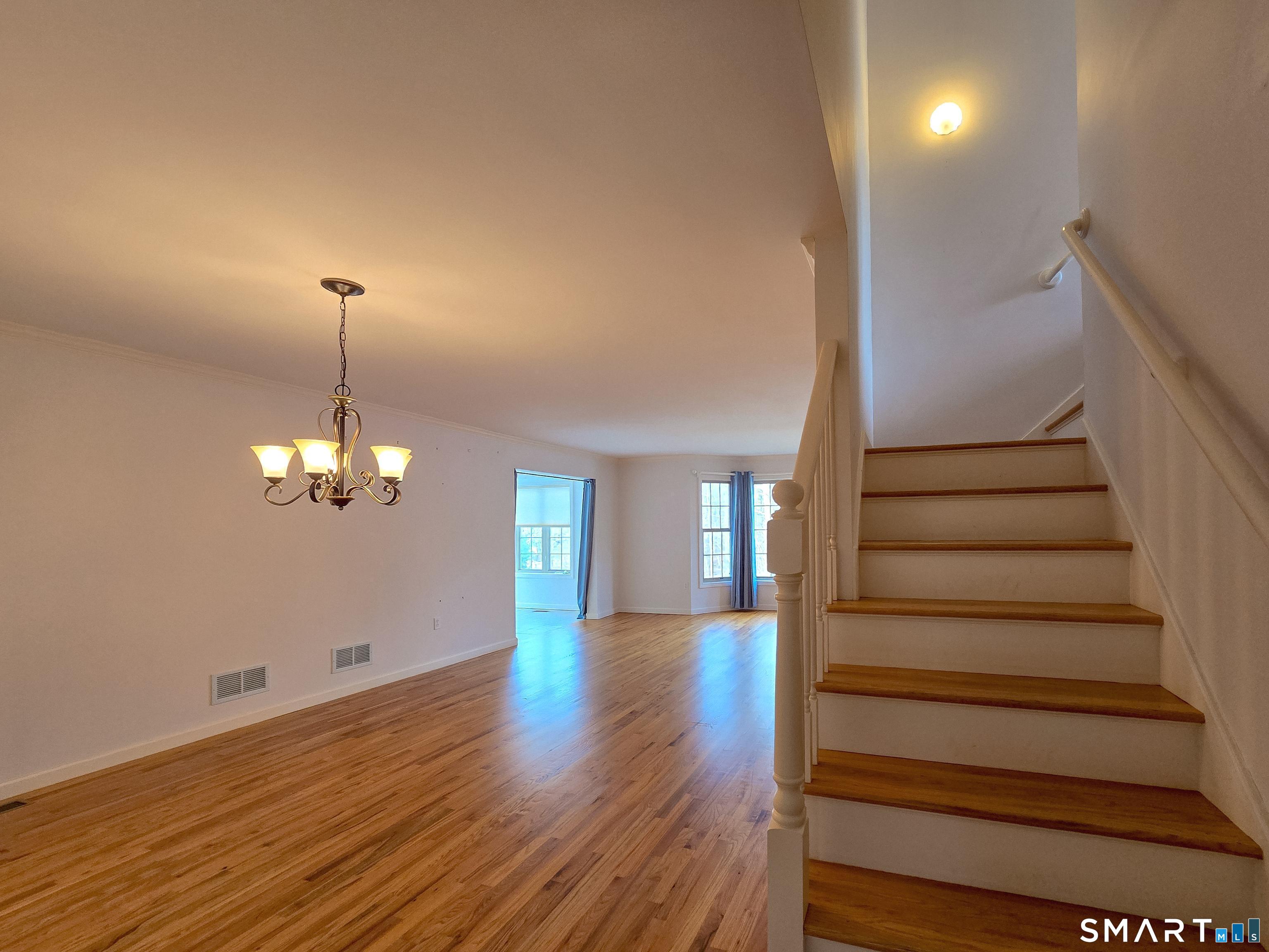 1 Bittersweet Lane, Unit 1 East Lyme, CT 06357 - Photo 8 of 35 a view of a room with wooden floor and staircase
