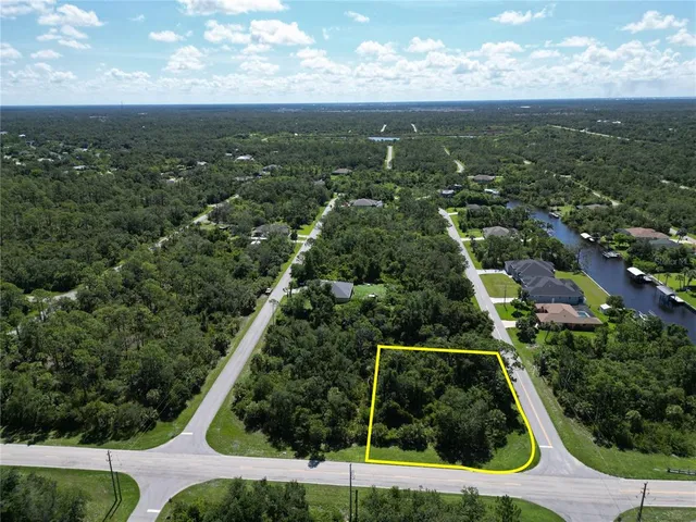 an aerial view of residential houses with outdoor space and trees