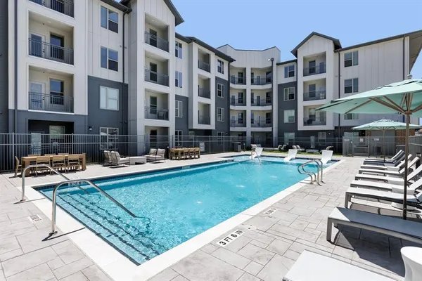 a swimming pool view with a outdoor seating
