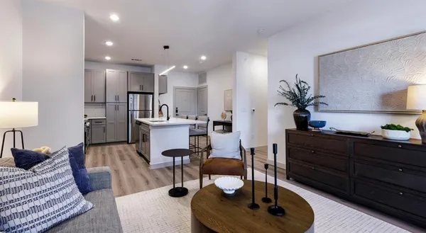 a living room with furniture and wooden floor