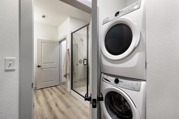 a view of a hallway with washer and dryer