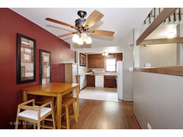 719 South Raven Road Shorewood, IL 60404 - Photo 3 of 11 a living room with stainless steel appliances kitchen island granite countertop furniture and a kitchen view