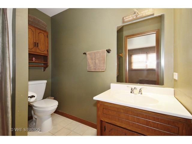 719 South Raven Road Shorewood, IL 60404 - Photo 7 of 11 a bathroom with a sink mirror and toilet
