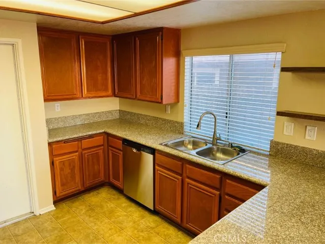 a kitchen with stainless steel appliances granite countertop a stove a microwave and a refrigerator