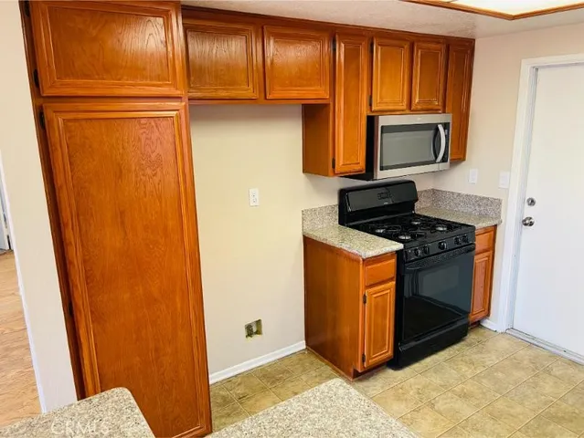 a kitchen with sink cabinets and stove top oven
