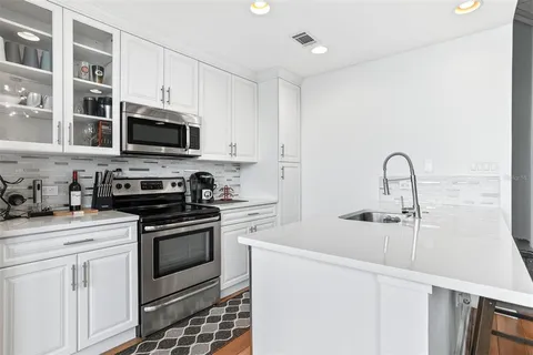 a kitchen with stainless steel appliances a refrigerator stove and sink