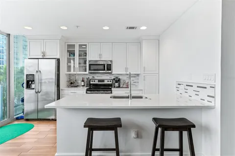 a bedroom with a bed and a view of kitchen