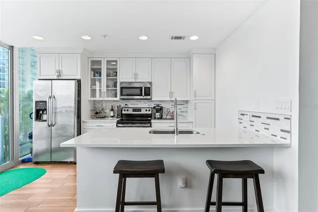 a bedroom with a bed and a view of kitchen