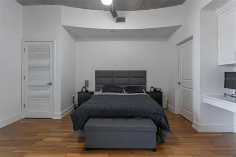 a bedroom with a bed and a television