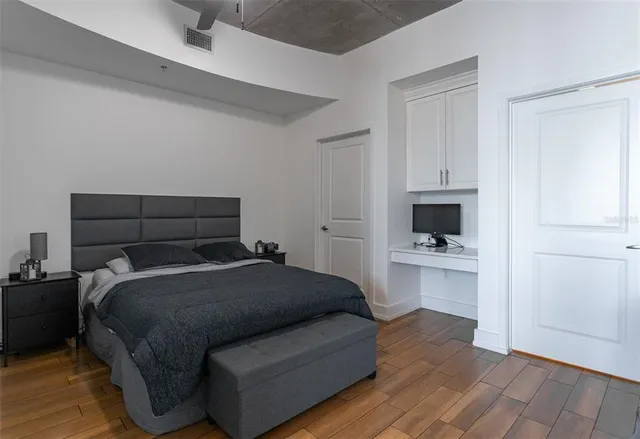 a bathroom with a granite countertop toilet a sink and a mirror