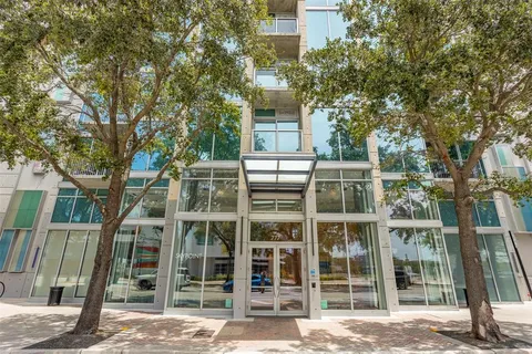 front view of a building with a tree