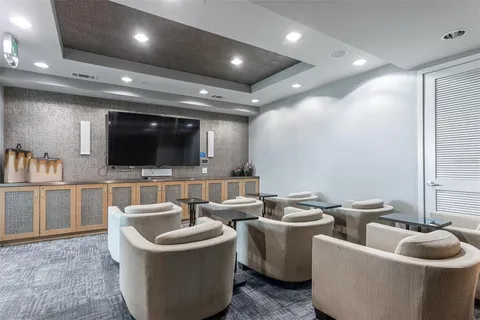 a view of a room with gym equipment and a large window