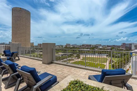 a view of balcony with couches and wooden floor