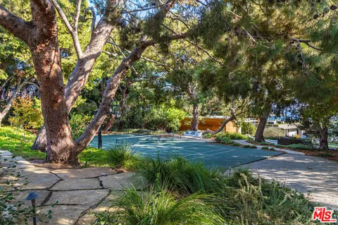 an aerial view of a house with a garden and swimming pool