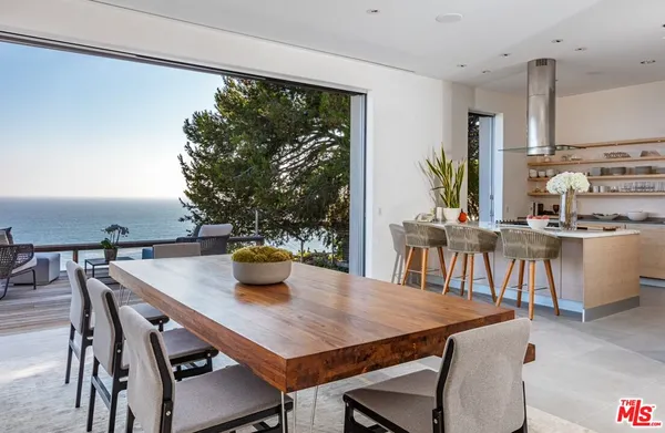 a view of a dining room with furniture and window