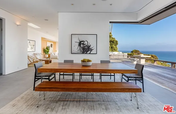 a sitting area with furniture and wooden floor