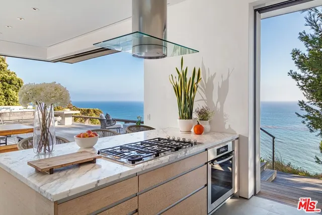 a kitchen view of a stove and a refrigerator
