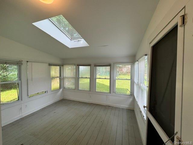 74 South Airmont Road Suffern, NY 10901 - Photo 18 of 42 Sunroom featuring a large skylight, multiple windows, painted wood-finish flooring, and a screen door